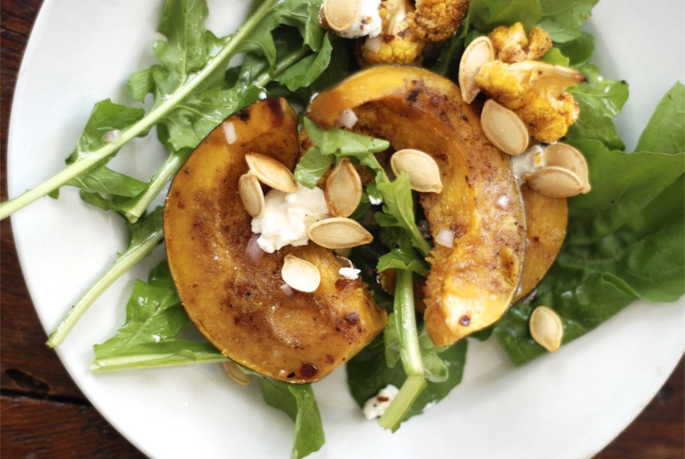 Arugula Salad with Roasted Curry Veggies, Goat Cheese, and Roasted Pumpkin Seeds