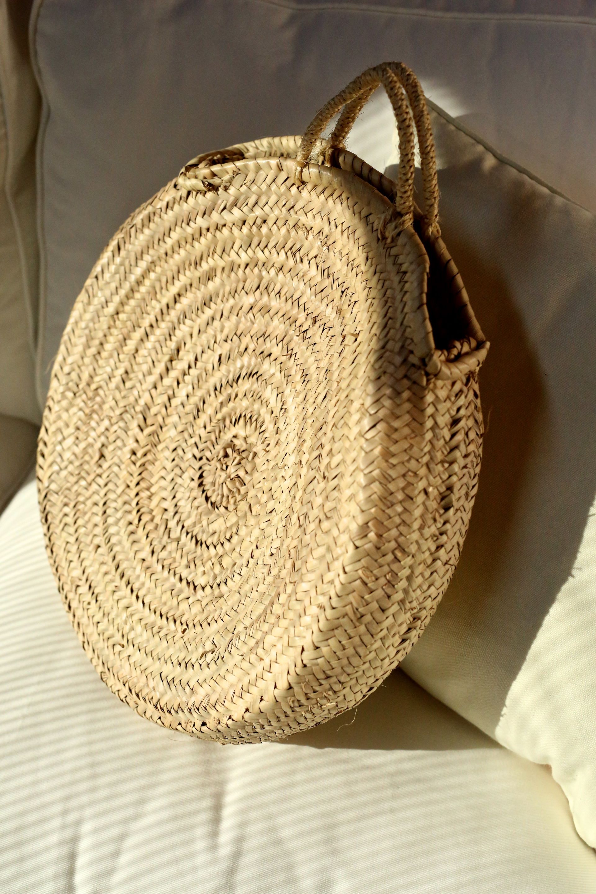 straw bag on a white couch