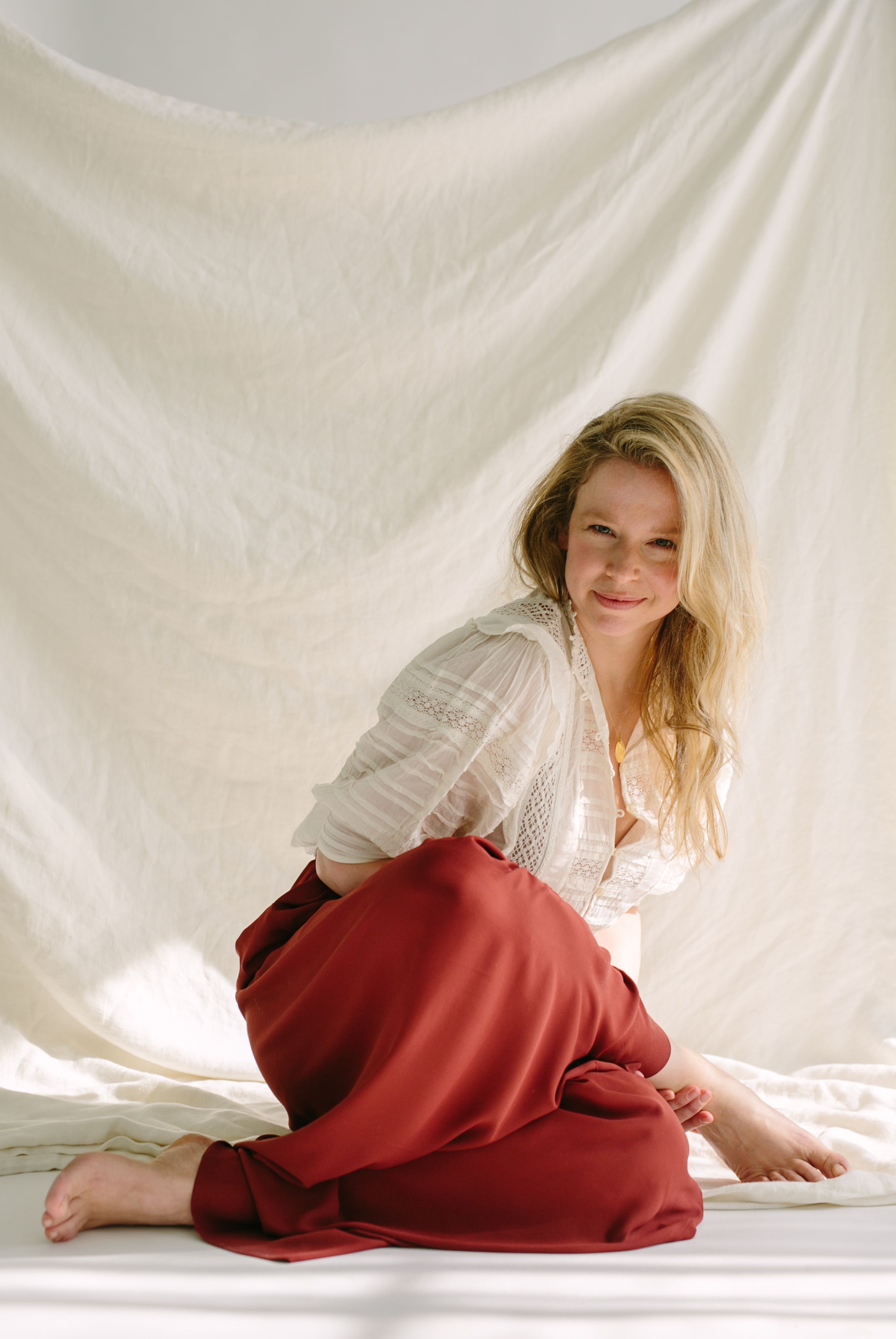 photo of Chrissy Carter in burgundy pants and a white top