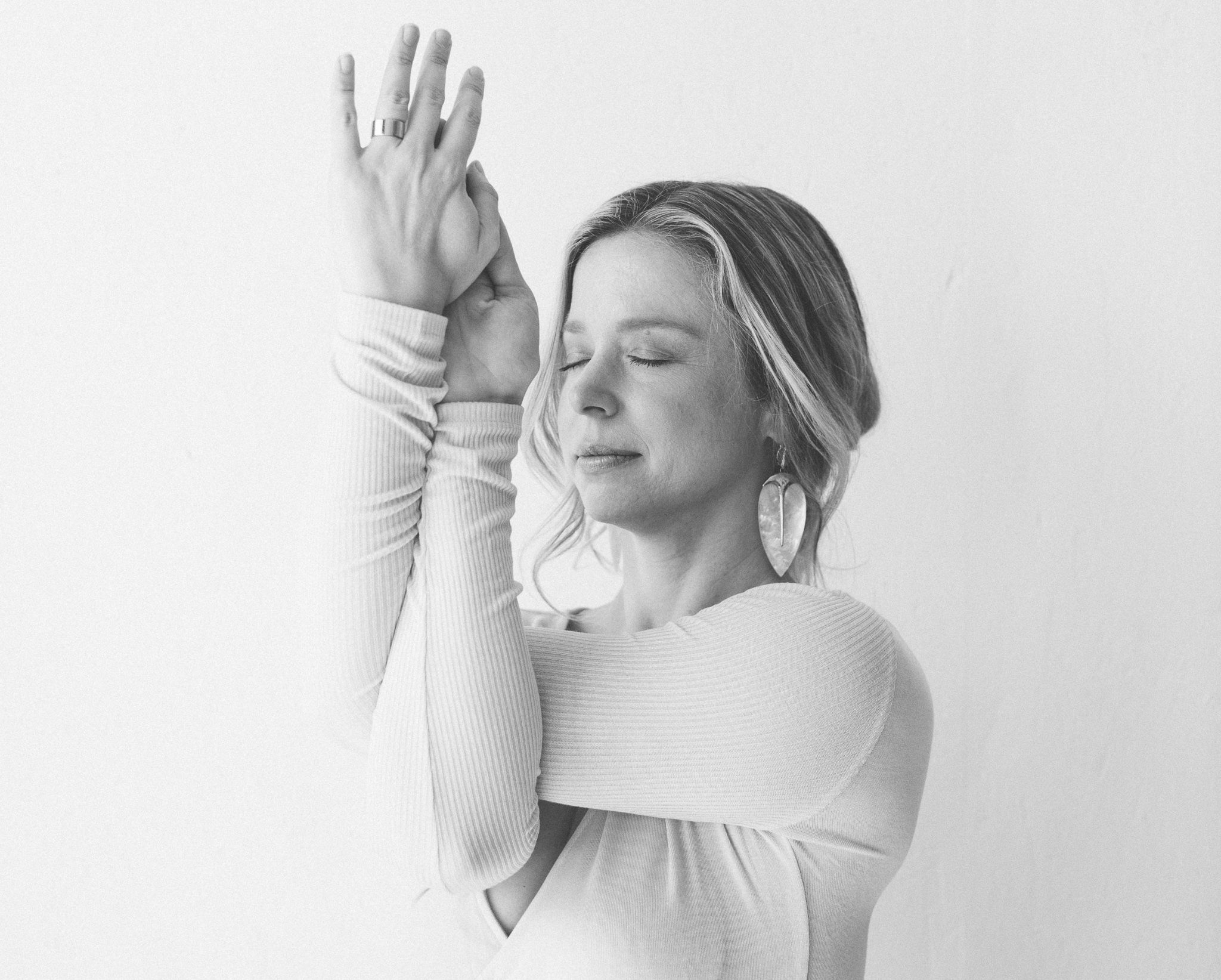 black and white photograph Chrissy Carter in Garudasana yoga pose