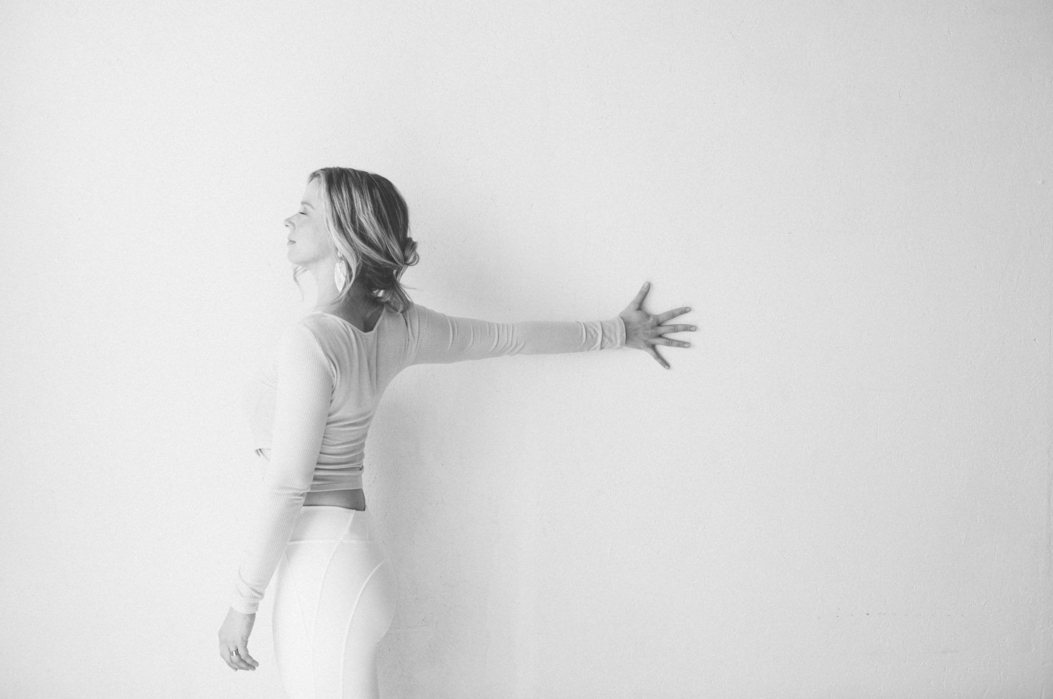 Yoga pose stretching arm at the wall