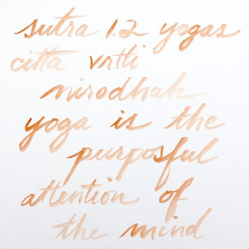orange handwriting in watercolor on white, Sutra 1.2 in Sanskrit and English