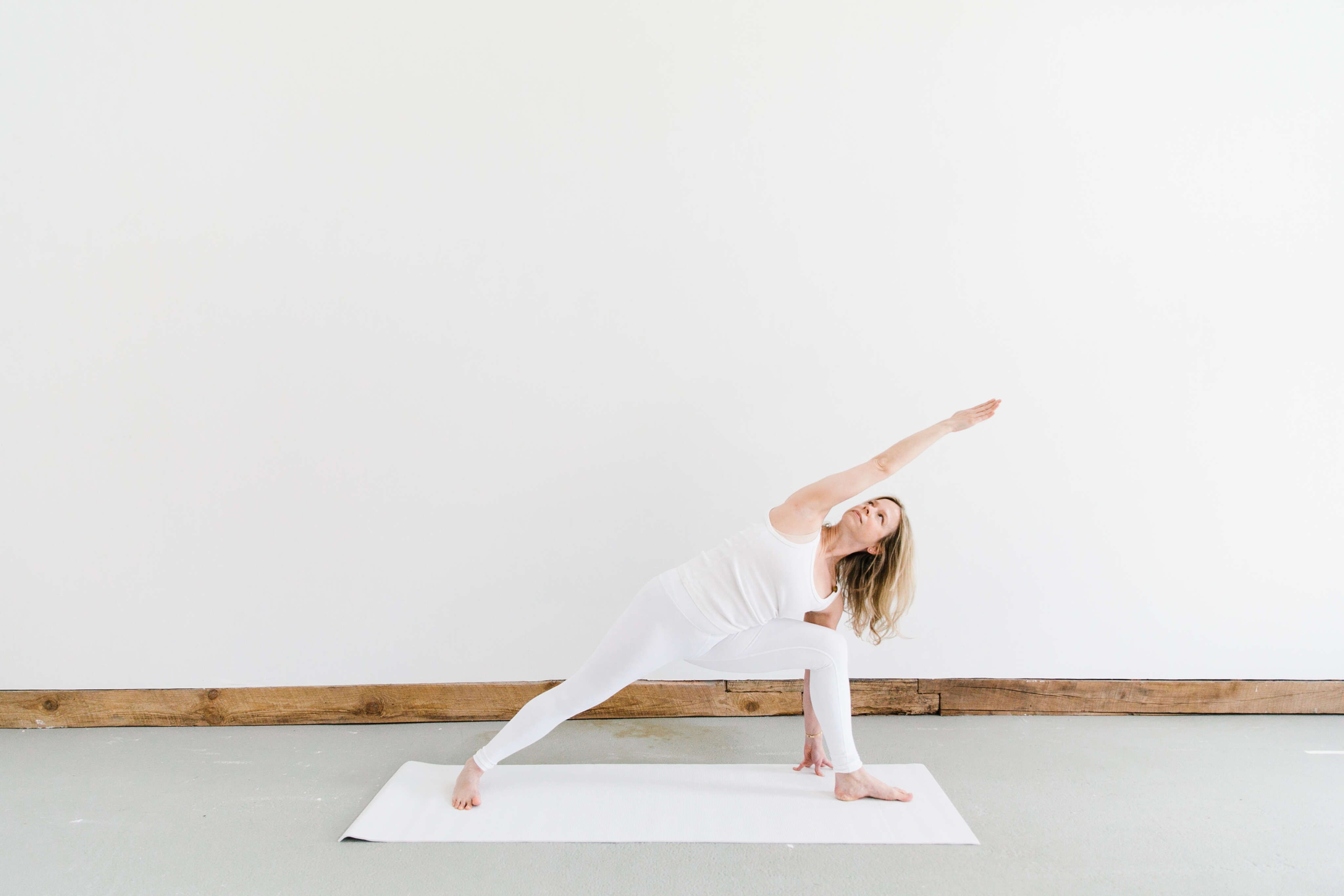 woman wearing white in yoga pose