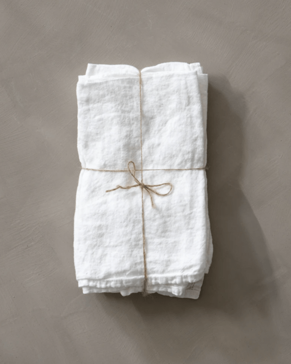 white linen napkins tied with string