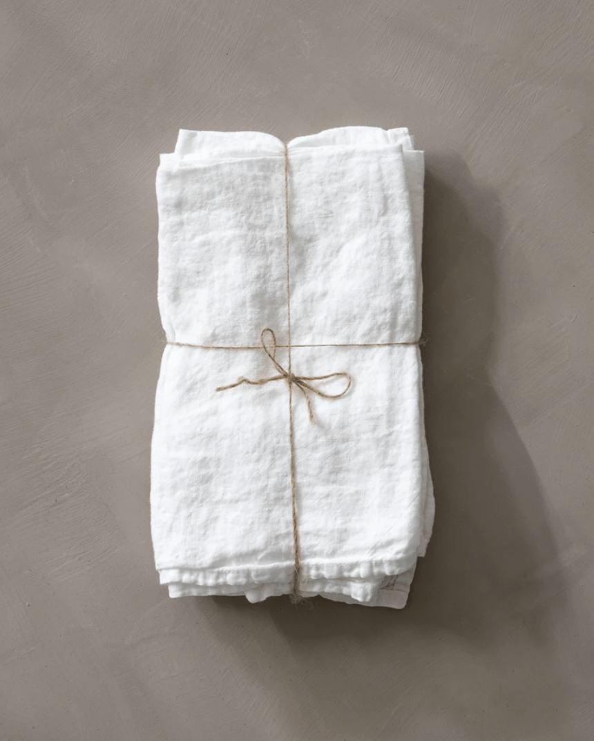 white linen napkins tied with string