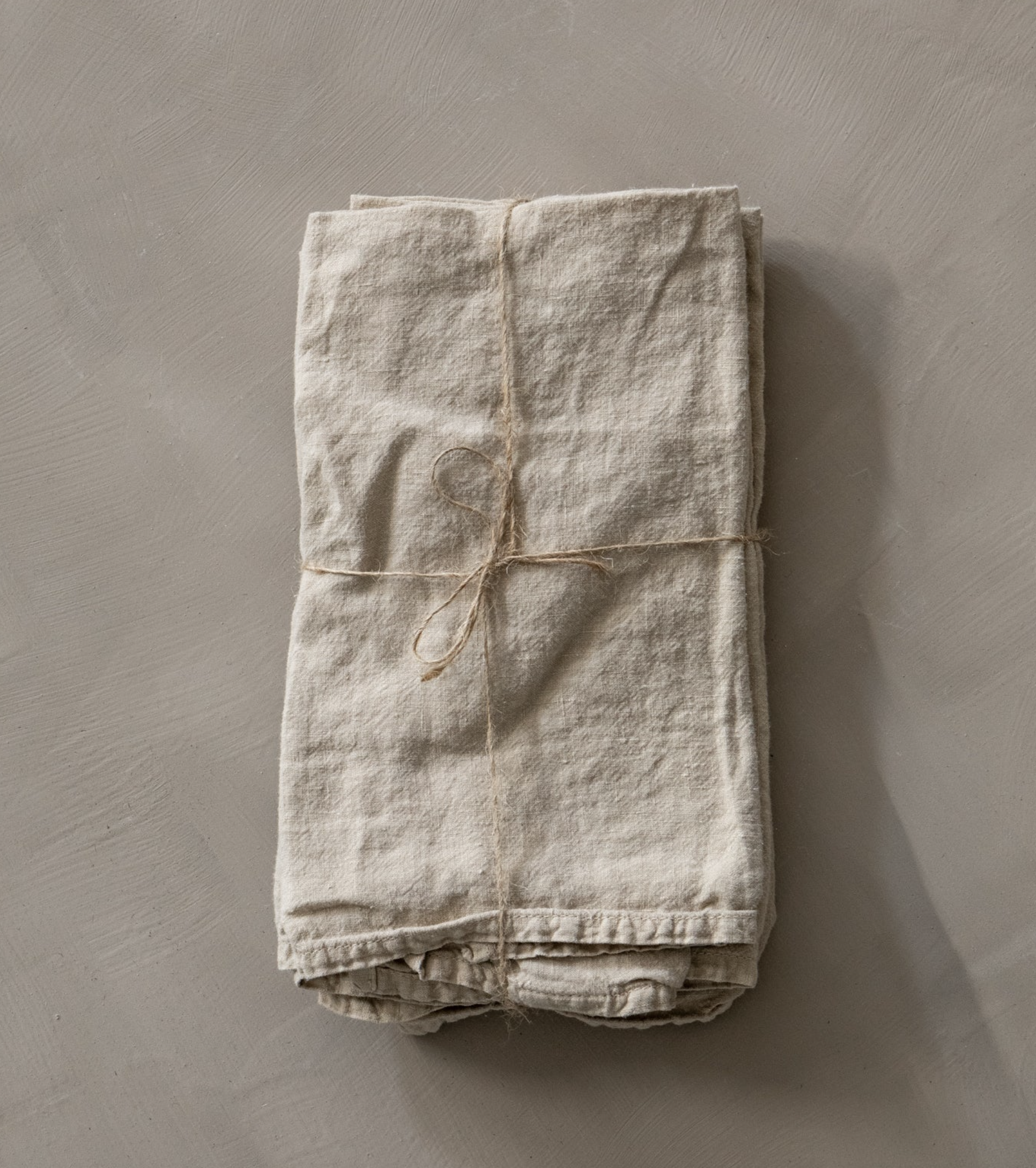 flax-colored linen napkin tied with string