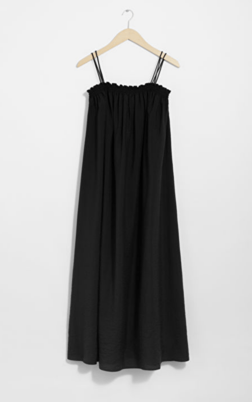 black spaghetti strap midi dress hanging on coat hanger