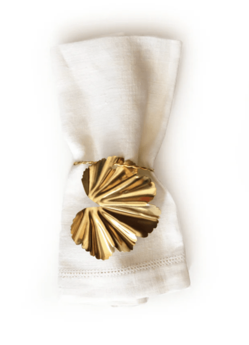 gold petal napkin ring around white napkin