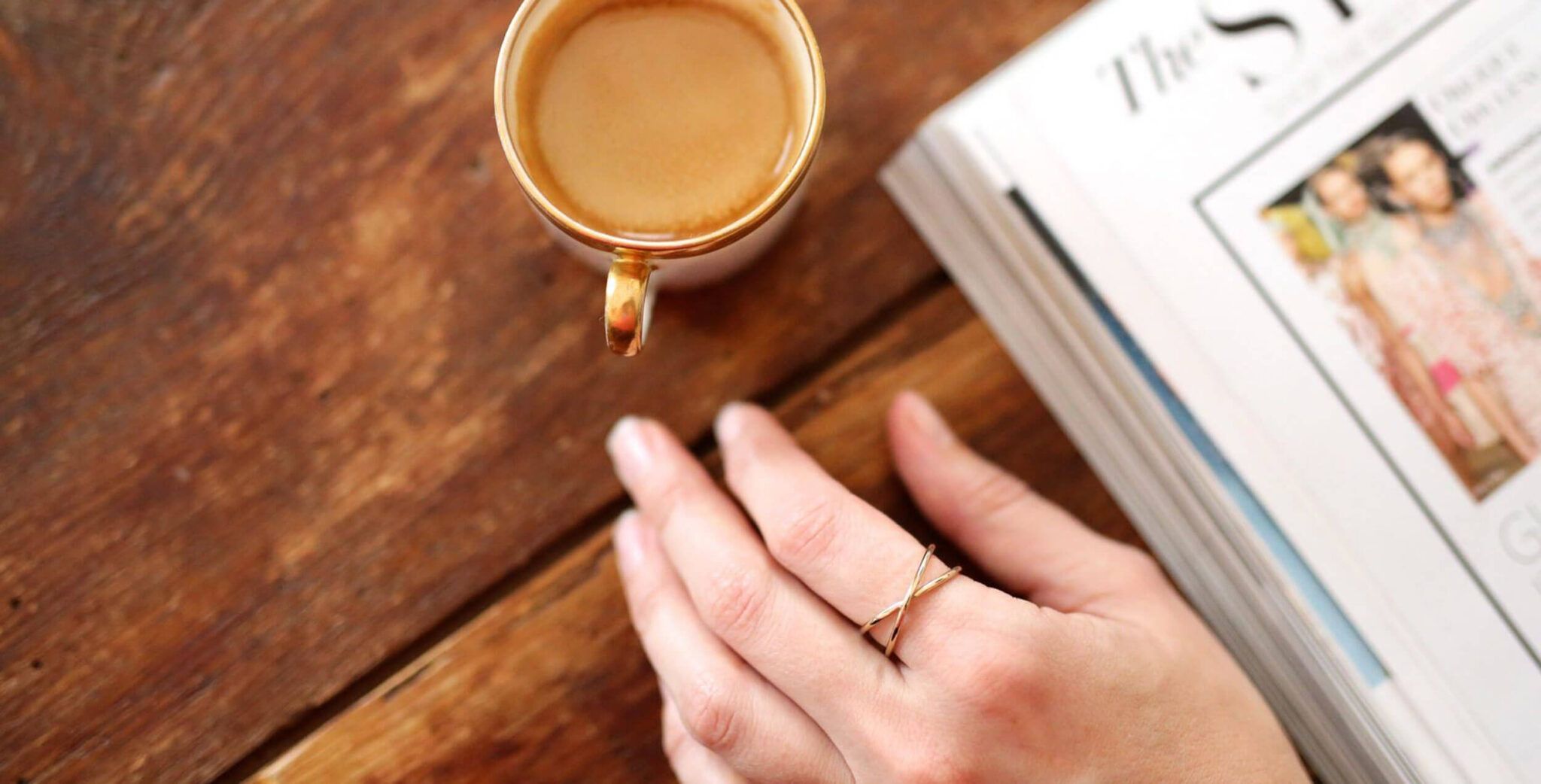 close up of hand on table with magazine